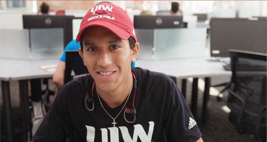 Male student wearing UIW hat and shirt