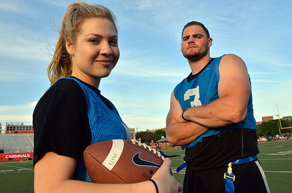 Female and male student athletes with football