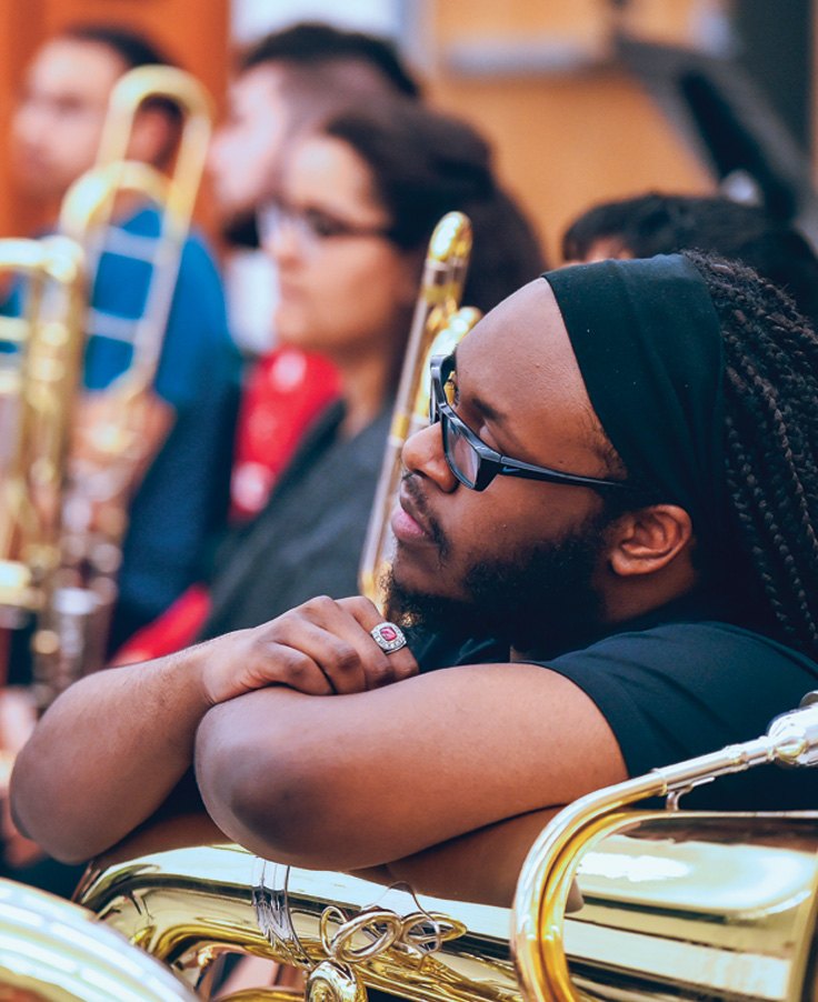 Male band student listening to lecture