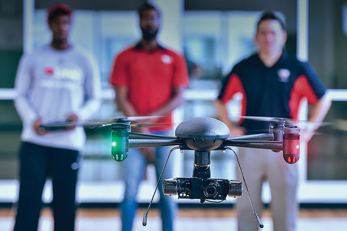 Students holding drone